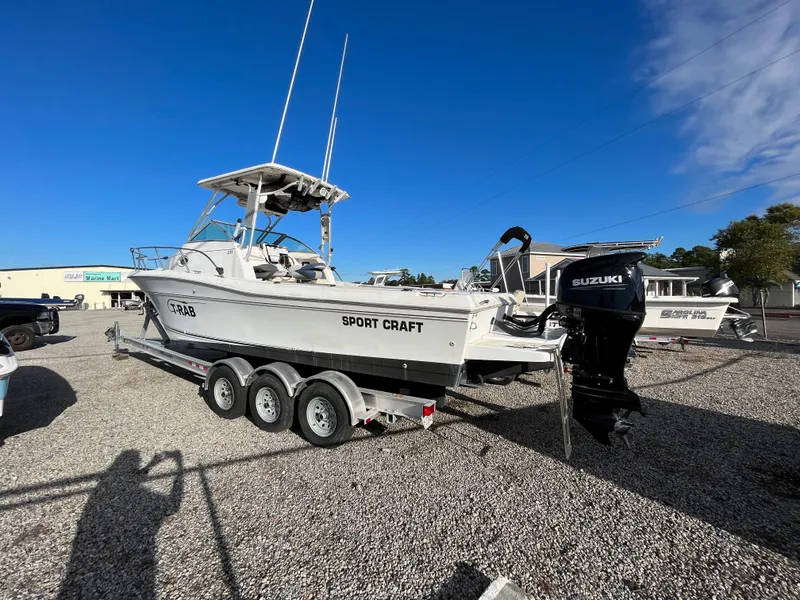 The Image of 1998 Sport-Craft 25 Walk Around boat on trailer with Suzuki outboard motor. - 0