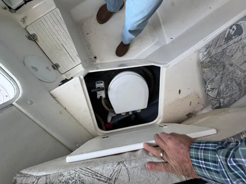 Slide: The Image of Interior view of a 1998 Sport-Craft 25 Walk Around boat showing a storage compartment. - 7