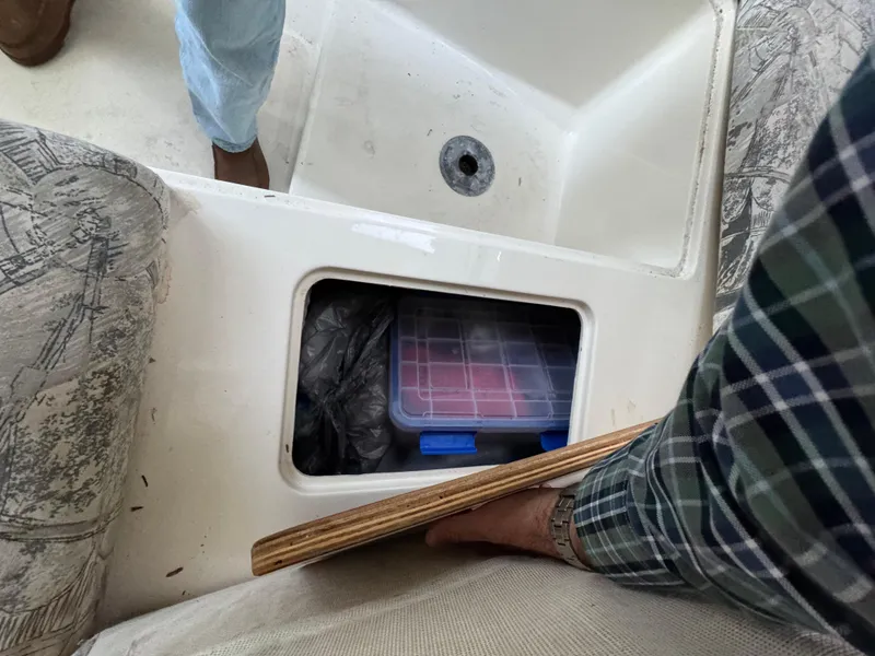 Slide: The Image of Storage compartment on a 1998 Sport-Craft 25 Walk Around boat with fishing gear. - 8