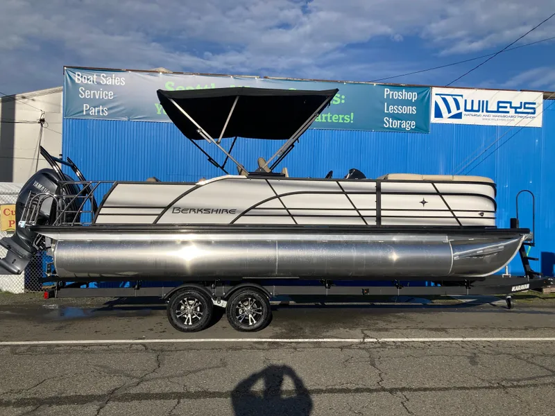 The Image of 2024 Berkshire 23ULE STS pontoon boat on trailer at dealership. - 0