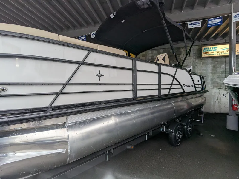 Slide: The Image of 2024 Berkshire 23ULE STS pontoon boat under a covered area. - 15