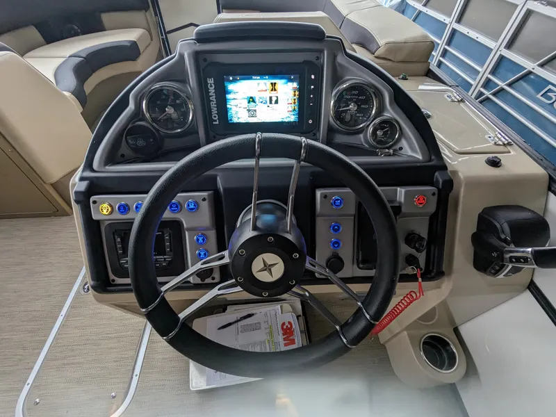 Slide: The Image of 2024 Berkshire 23ULE STS boat dashboard with steering wheel and control panel. - 6