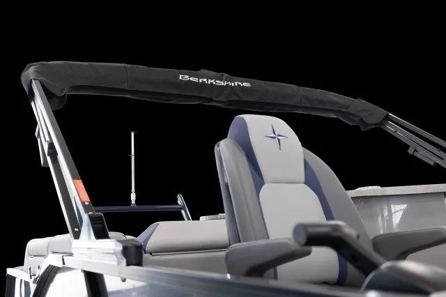 Slide: The Image of 2024 Berkshire 23ULE STS boat interior with cushioned seats and canopy. - 8