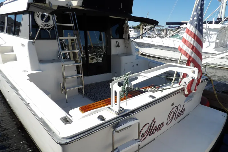 Slide: The Image of 1991 Silverton 41 yacht docked with American flag and ladder. - 10