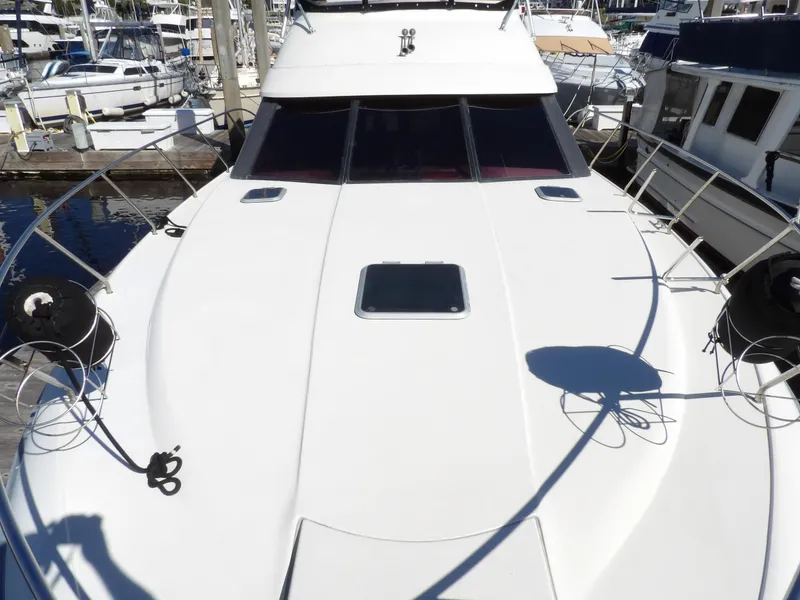 Slide: The Image of 1991 Silverton 41 yacht docked at a marina, top deck view. - 13