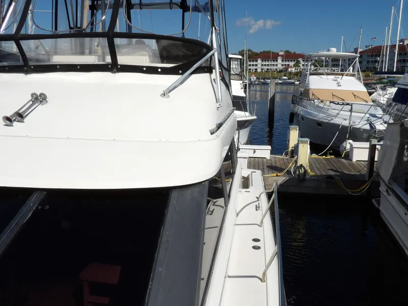 Slide: The Image of 1991 Silverton 41 yacht docked at a marina on a sunny day. - 14