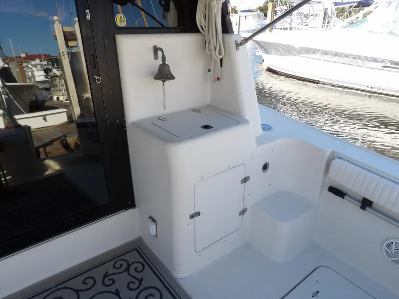 Slide: The Image of 1991 Silverton 41 boat deck with storage compartments and a bell. - 19