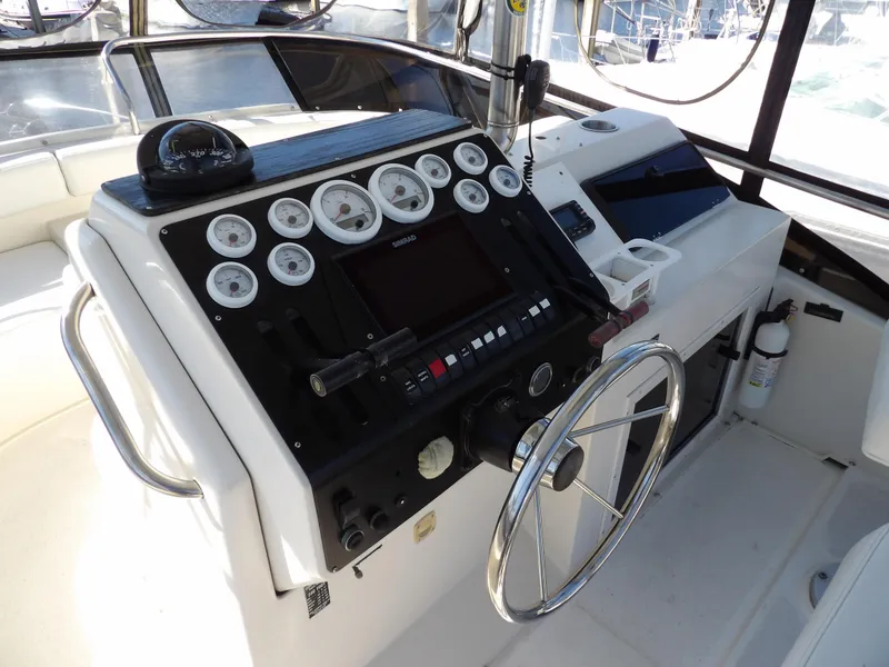Slide: The Image of 1991 Silverton 41 boat helm with steering wheel and control panel. - 23