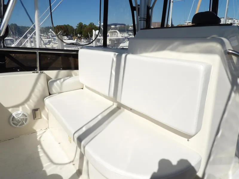 Slide: The Image of 1991 Silverton 41 boat interior with white cushioned seating. - 30