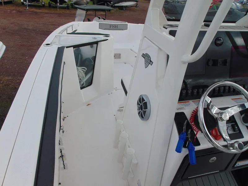 Slide: The Image of 2022 Yamaha Boats 252 FSH® SPORT interior, featuring helm station and storage compartments. - 3