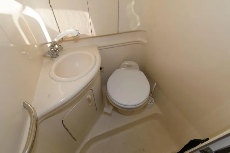 Slide: The Image of Compact bathroom in 2005 Sea Ray 280 Sundancer with sink and toilet. - 11