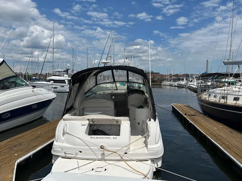Slide: The Image of 2005 Sea Ray 280 Sundancer docked at marina under blue sky. - 2