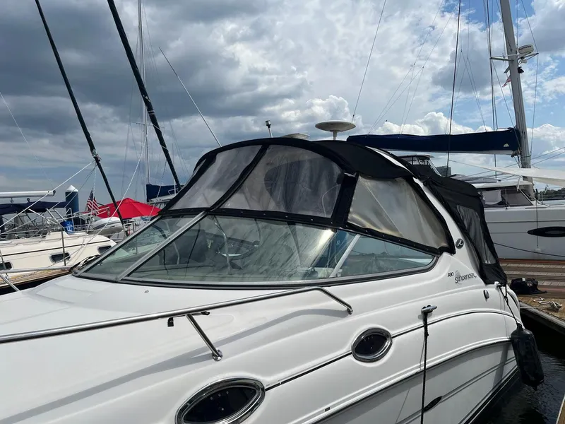 Slide: The Image of 2005 Sea Ray 280 Sundancer boat docked at a marina under cloudy skies. - 3