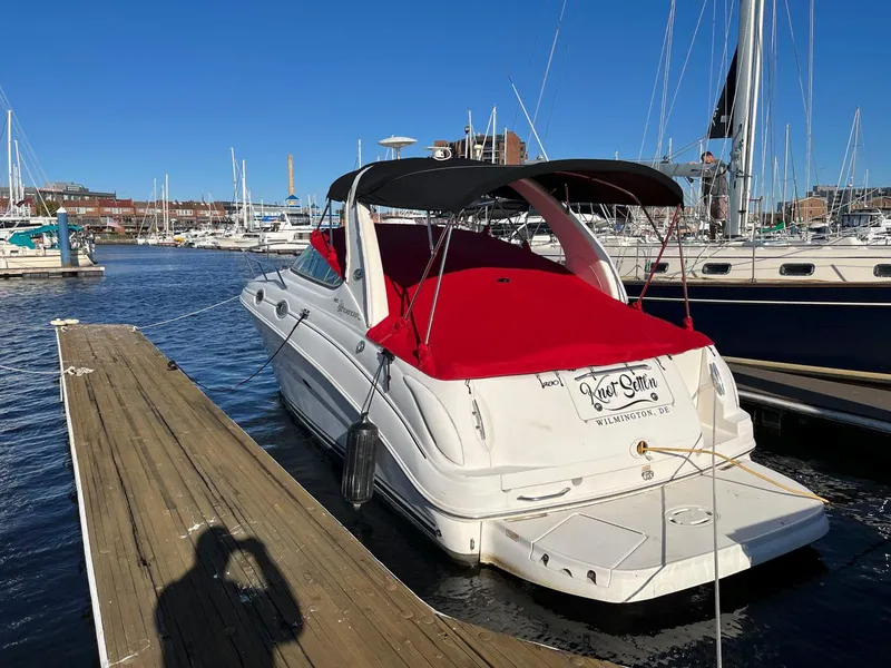 Slide: The Image of 2005 Sea Ray 280 Sundancer docked at marina with red cover. - 5