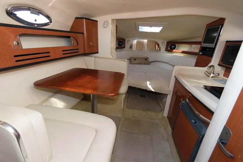 Slide: The Image of Interior cabin of 2005 Sea Ray 280 Sundancer with dining area, kitchenette, and sleeping quarters. - 6