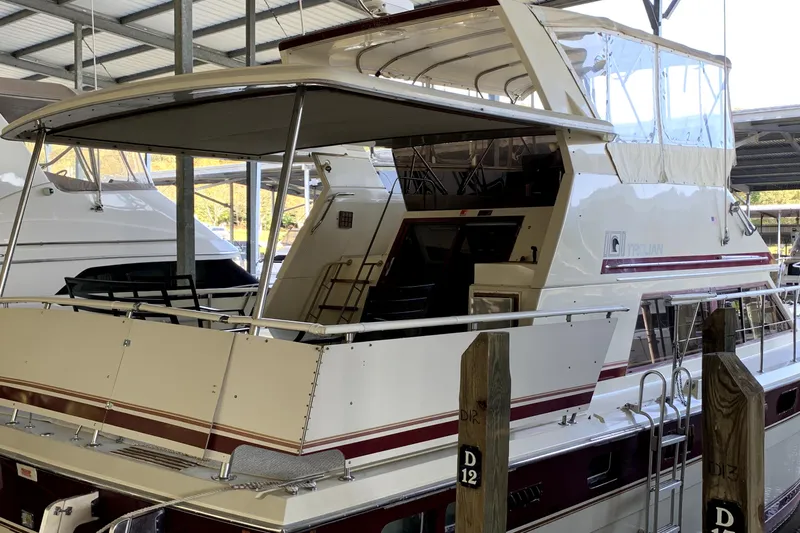 Slide: The Image of 1982 Trojan F 40 yacht docked in a covered marina. - 1