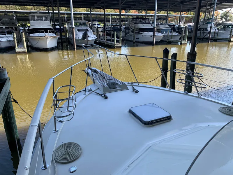Slide: The Image of 1982 Trojan F 40 boat docked in a marina with other boats. - 10