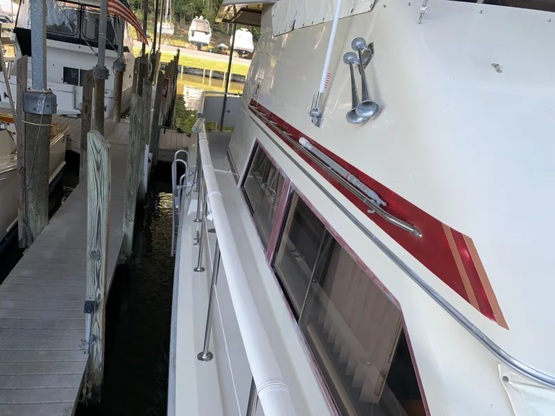 Slide: The Image of 1982 Trojan F 40 boat docked at a marina. - 12