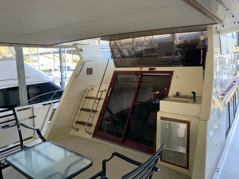 Slide: The Image of 1982 Trojan F 40 yacht deck with seating and sliding door. - 14