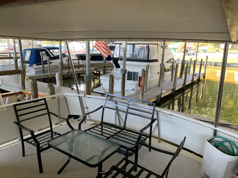 Slide: The Image of Outdoor seating area on a 1982 Trojan F 40 yacht docked at a marina. - 15