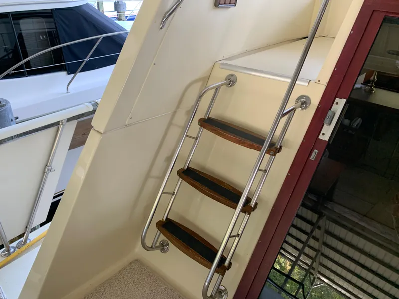 Slide: The Image of Staircase on 1982 Trojan F 40 boat with wooden steps and metal railings. - 16