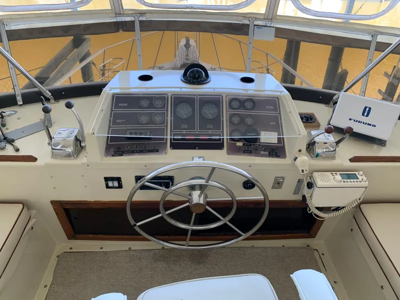 Slide: The Image of 1982 Trojan F 40 boat helm with steering wheel, gauges, and navigation equipment. - 18