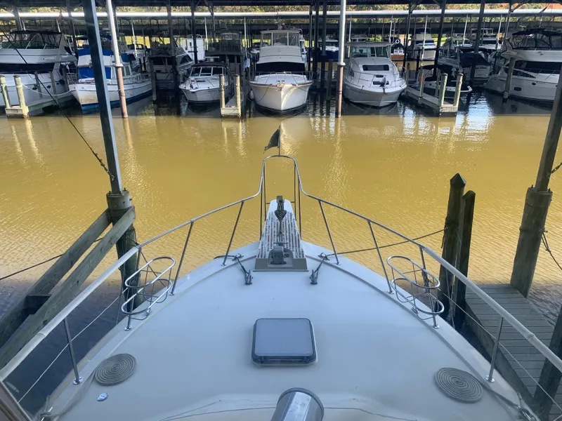 Slide: The Image of 1982 Trojan F 40 boat docked in a marina with other boats. - 21