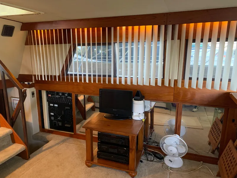 Slide: The Image of Interior of 1982 Trojan F 40 yacht with wooden decor and entertainment setup. - 25