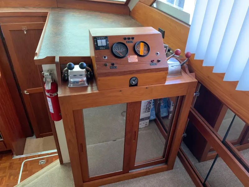 Slide: The Image of 1982 Trojan F 40 boat helm station with control panel and fire extinguisher. - 26