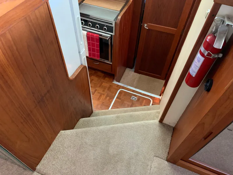 Slide: The Image of Interior of 1982 Trojan F 40 boat with stairs, kitchen, and fire extinguisher. - 27