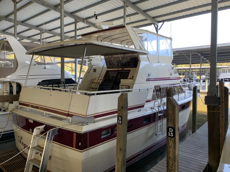 Slide: The Image of 1982 Trojan F 40 yacht docked in a covered marina. - 3