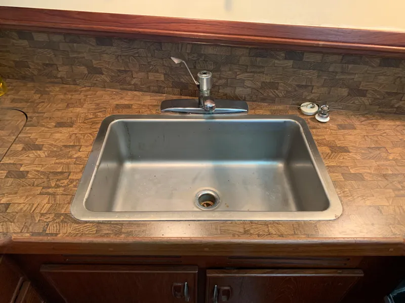 Slide: The Image of 1982 Trojan F 40 stainless steel sink with wooden countertop and backsplash. - 31