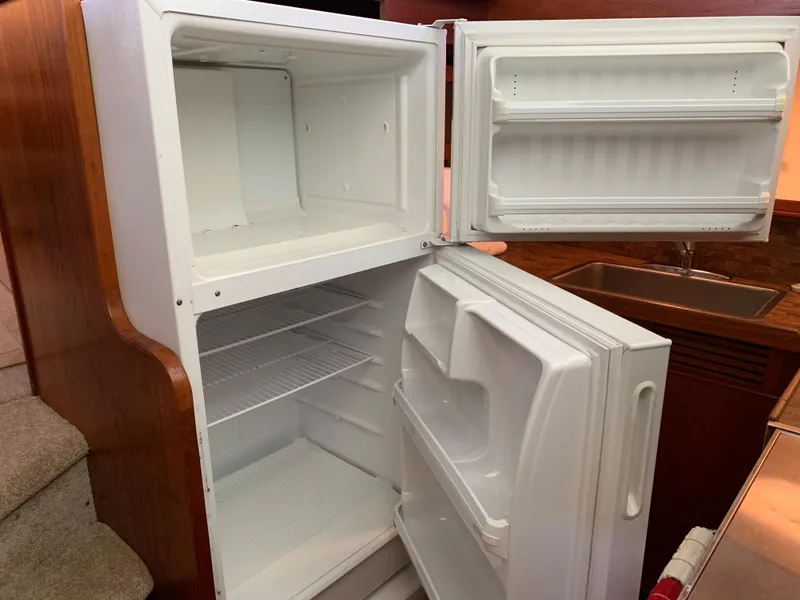 Slide: The Image of 1982 Trojan F 40 refrigerator with open doors in a boat galley. - 32