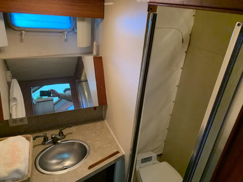 Slide: The Image of 1982 Trojan F 40 boat bathroom with sink, mirror, and shower. - 33
