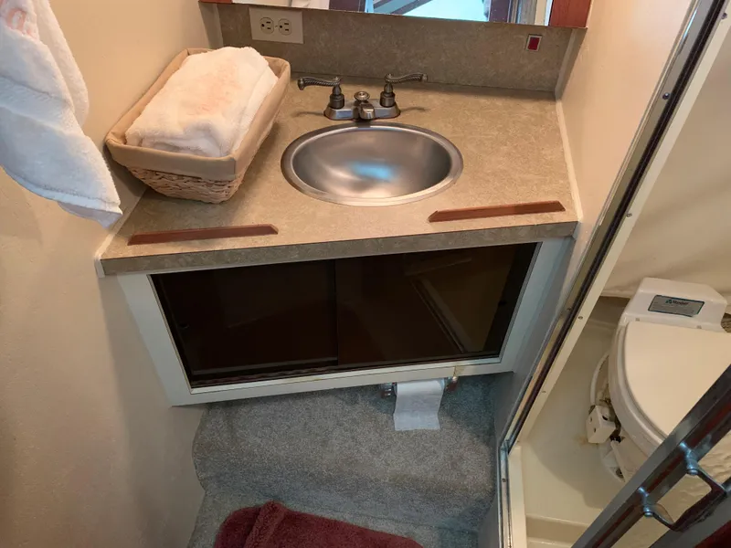 Slide: The Image of 1982 Trojan F 40 boat bathroom with sink, toilet, and towel basket. - 35