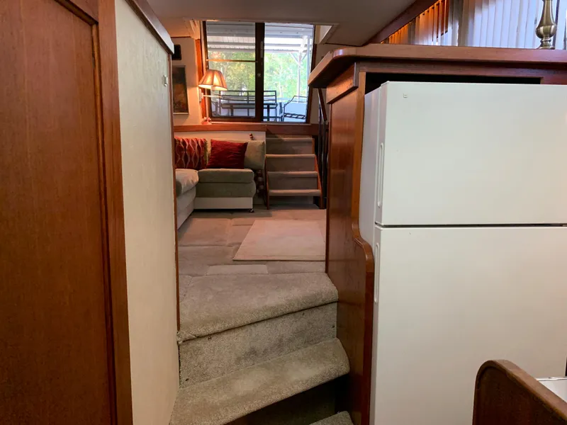 Slide: The Image of Interior of 1982 Trojan F 40 boat with stairs, sofa, and refrigerator. - 36