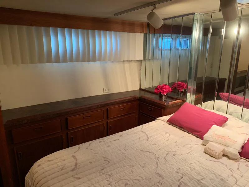 Slide: The Image of 1982 Trojan F 40 bedroom with mirrored walls, wooden cabinets, and pink accents. - 39