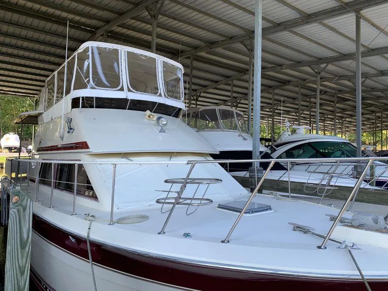 Slide: The Image of 1982 Trojan F 40 yacht docked in a covered marina. - 4