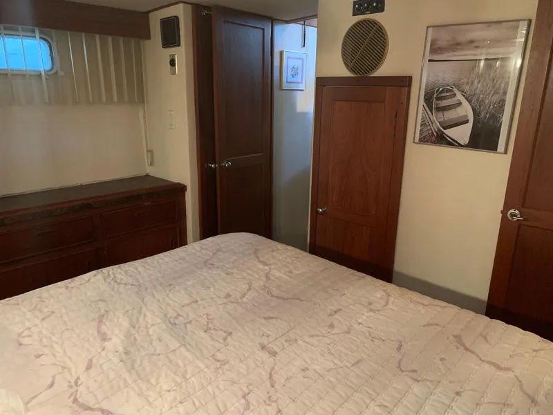 Slide: The Image of Cozy bedroom interior of 1982 Trojan F 40 boat with wooden cabinets and nautical decor. - 41