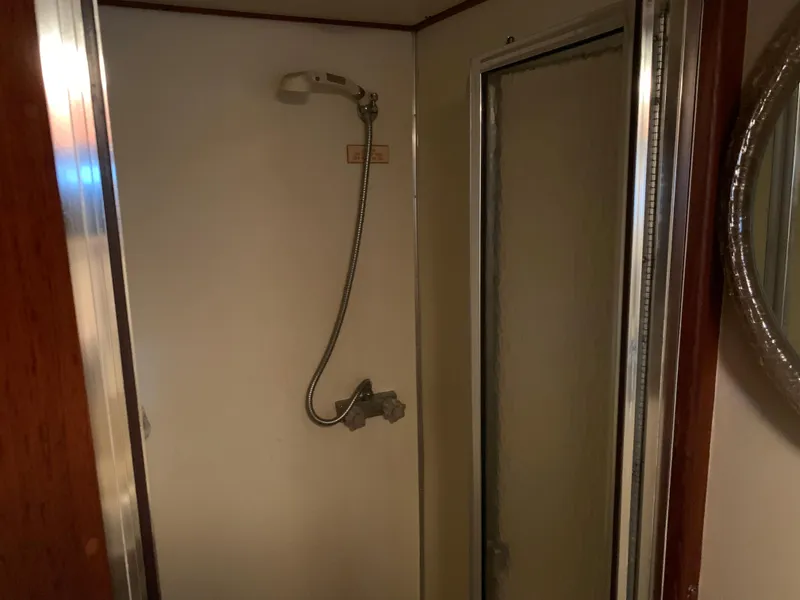 Slide: The Image of 1982 Trojan F 40 boat shower with handheld showerhead and sliding door. - 44