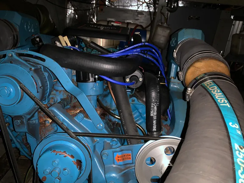 Slide: The Image of 1982 Trojan F 40 engine with blue components and hoses in a boat. - 49