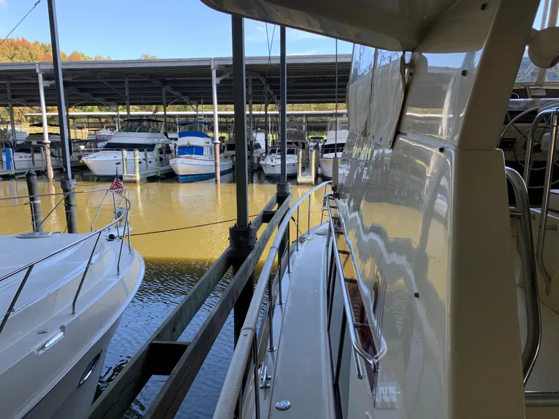 Slide: The Image of 1982 Trojan F 40 yacht docked in a marina with other boats. - 9