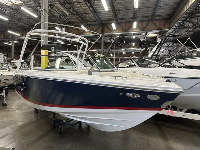Slide: The Image of 2022 Cobalt 220S boat in a showroom, blue hull with red stripe. - 3