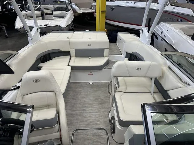 Slide: The Image of 2022 Cobalt 220S boat interior with white and gray seating in showroom. - 7