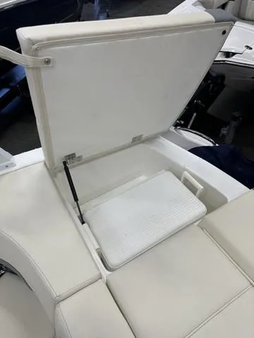 Slide: The Image of 2022 Cobalt 220S boat with open storage compartment and white cushioned seating. - 9