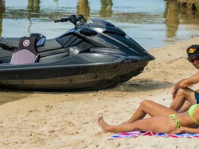 Slide: The Image of 2024 Yamaha Waverunner GP SVHO™ with Audio on sandy beach, people relaxing nearby. - 17
