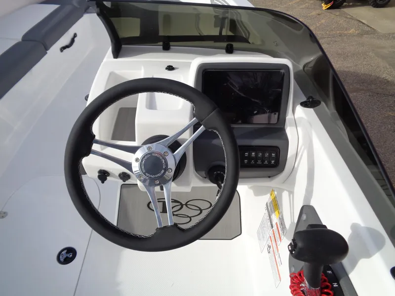 Slide: The Image of 2024 Tahoe T21 boat dashboard with steering wheel and control panel. - 10