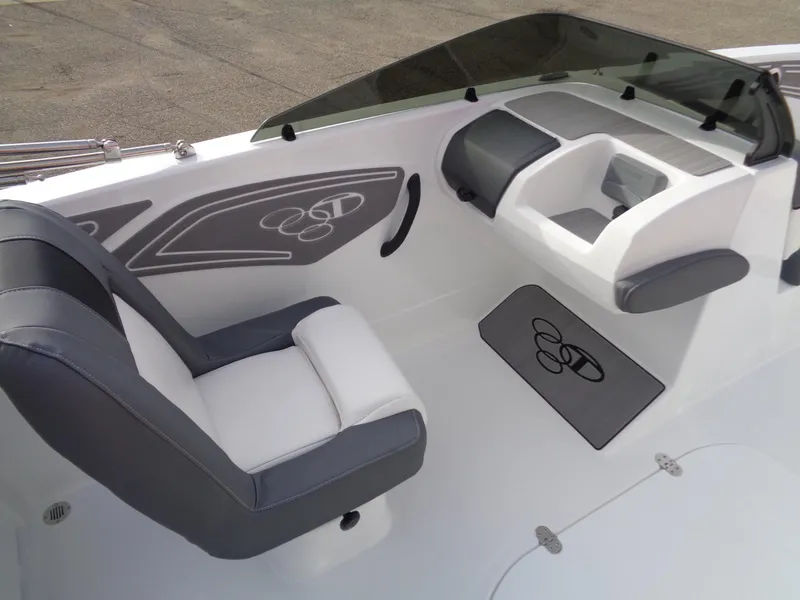 Slide: The Image of 2024 Tahoe T21 boat interior with gray and white seating and dashboard. - 11