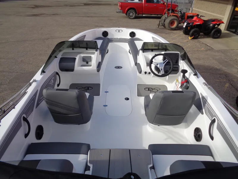 Slide: The Image of 2024 Tahoe T21 boat interior with gray seating and steering console. - 5