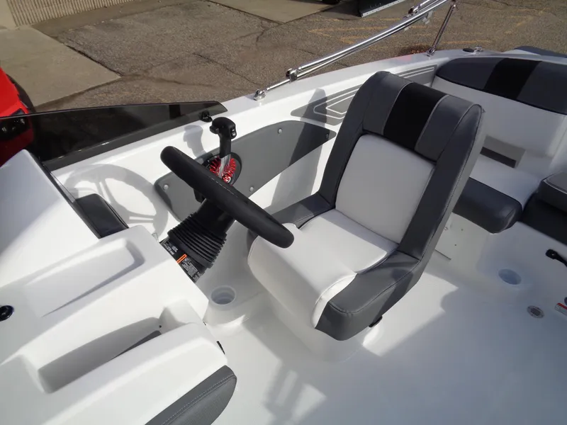 Slide: The Image of 2024 Tahoe T21 boat interior with steering wheel and captain's chair. - 8